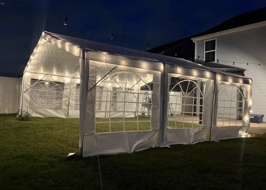 20x20 ft tent set up on a grassy field, perfect for medium gatherings
